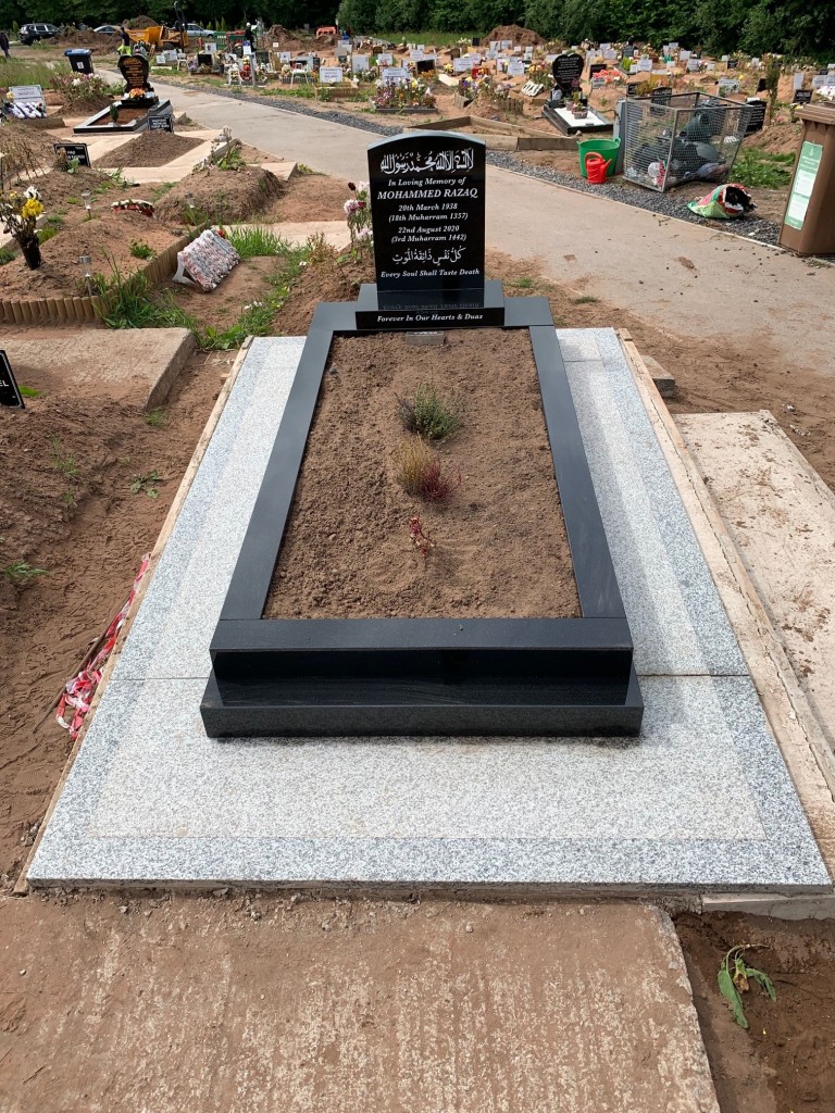 Medium Black Camber Headstone With Kerbs And A Black Granite Frame