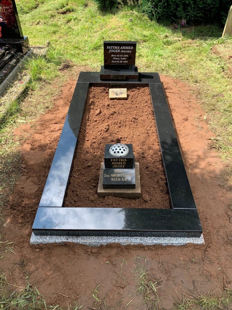 Small Black Headstone With Matching Black Kerbs On A Frame Landing